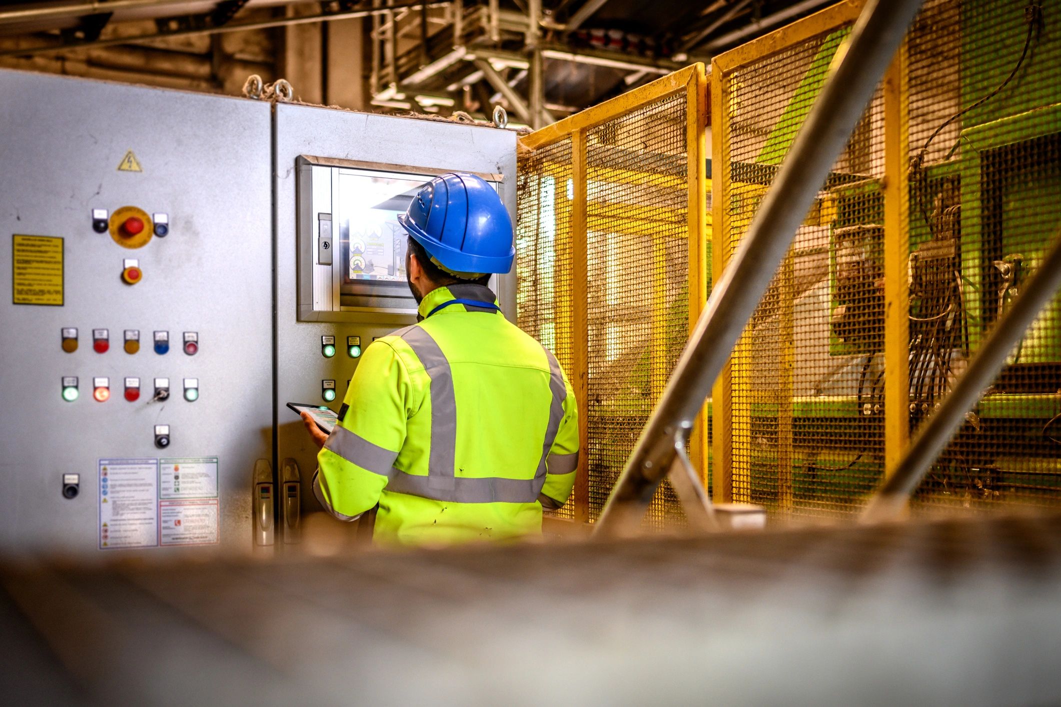 Industrial operator monitoring equipment on site